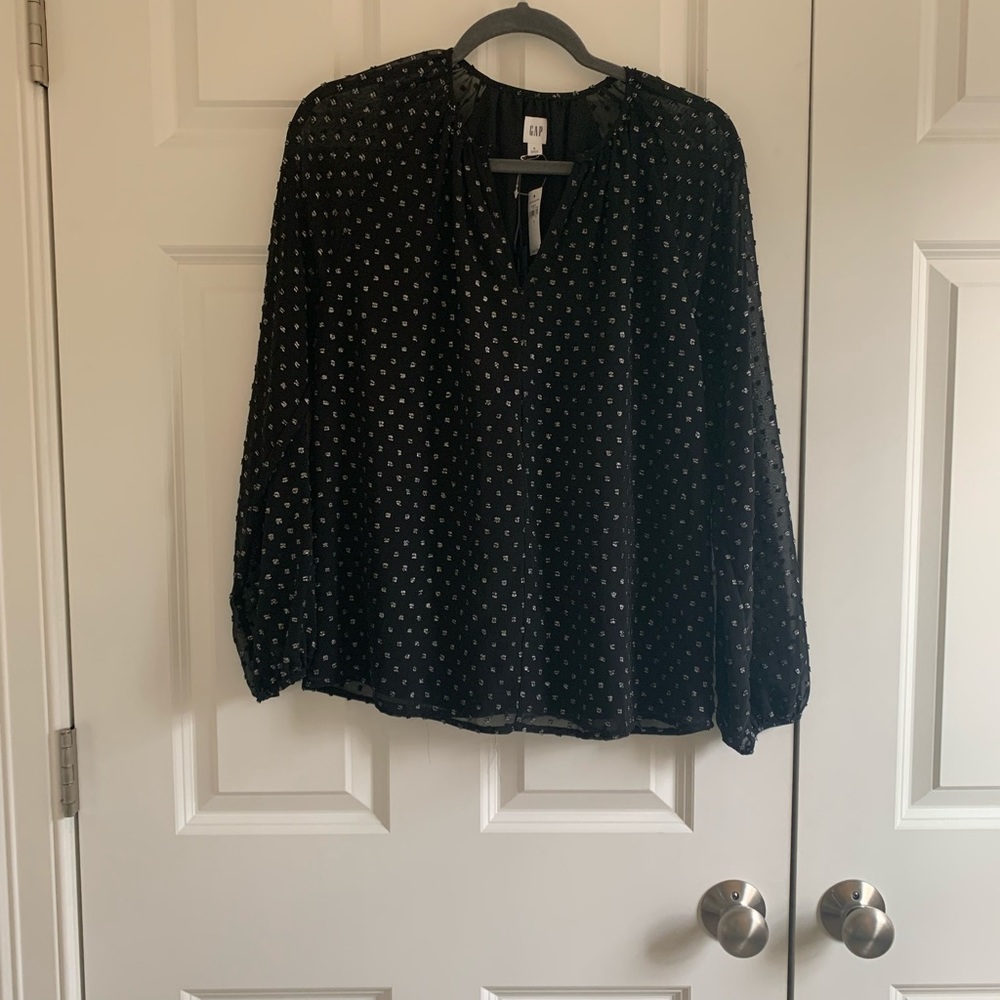 Black blouse with metallic silver accents and a button closure back